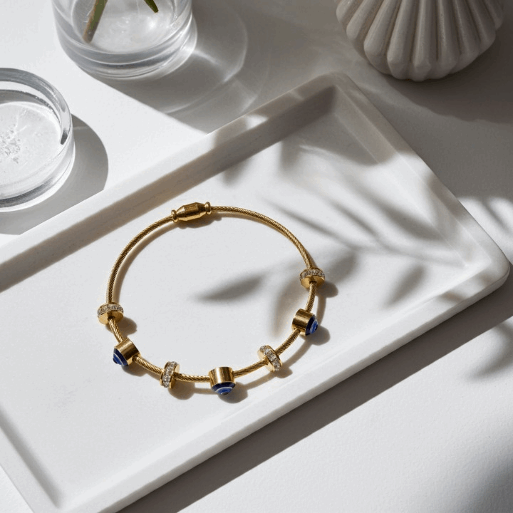 Golden Charm Bracelet with Blue Accents & Crystal Detailing – Modern Luxe Jewelry